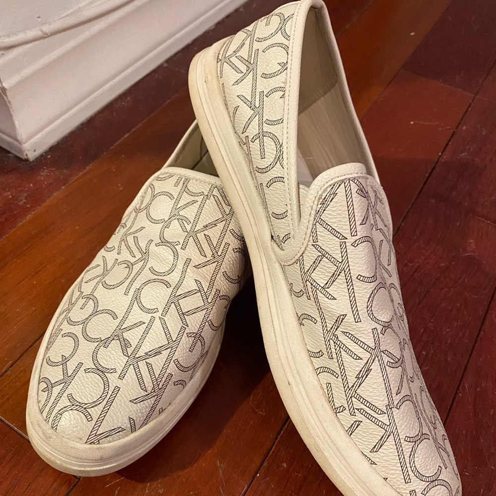 Adorable Calvin Klein slip on white sneakers! Lightly worn.
